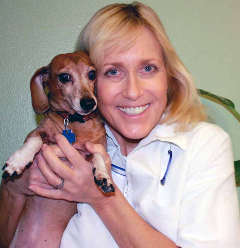 Photo of Dr. Dee Thornell with treated dog.