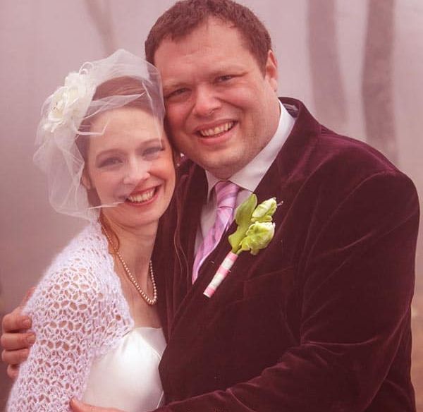 Charles Pol in wedding dress with his wife, Beth Oakes